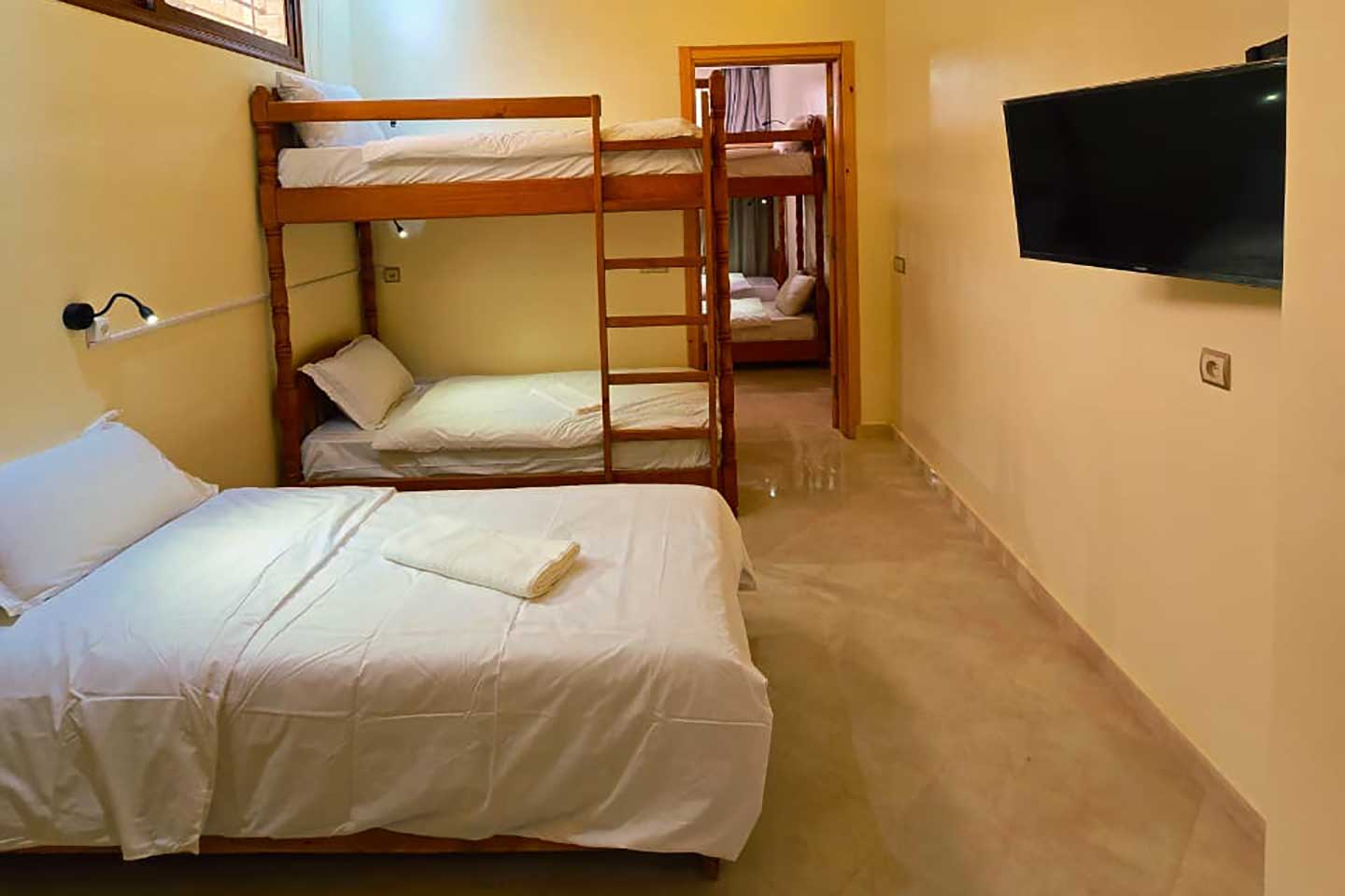 Shared dorm room with bunk beds at Golden Wave surf camp
