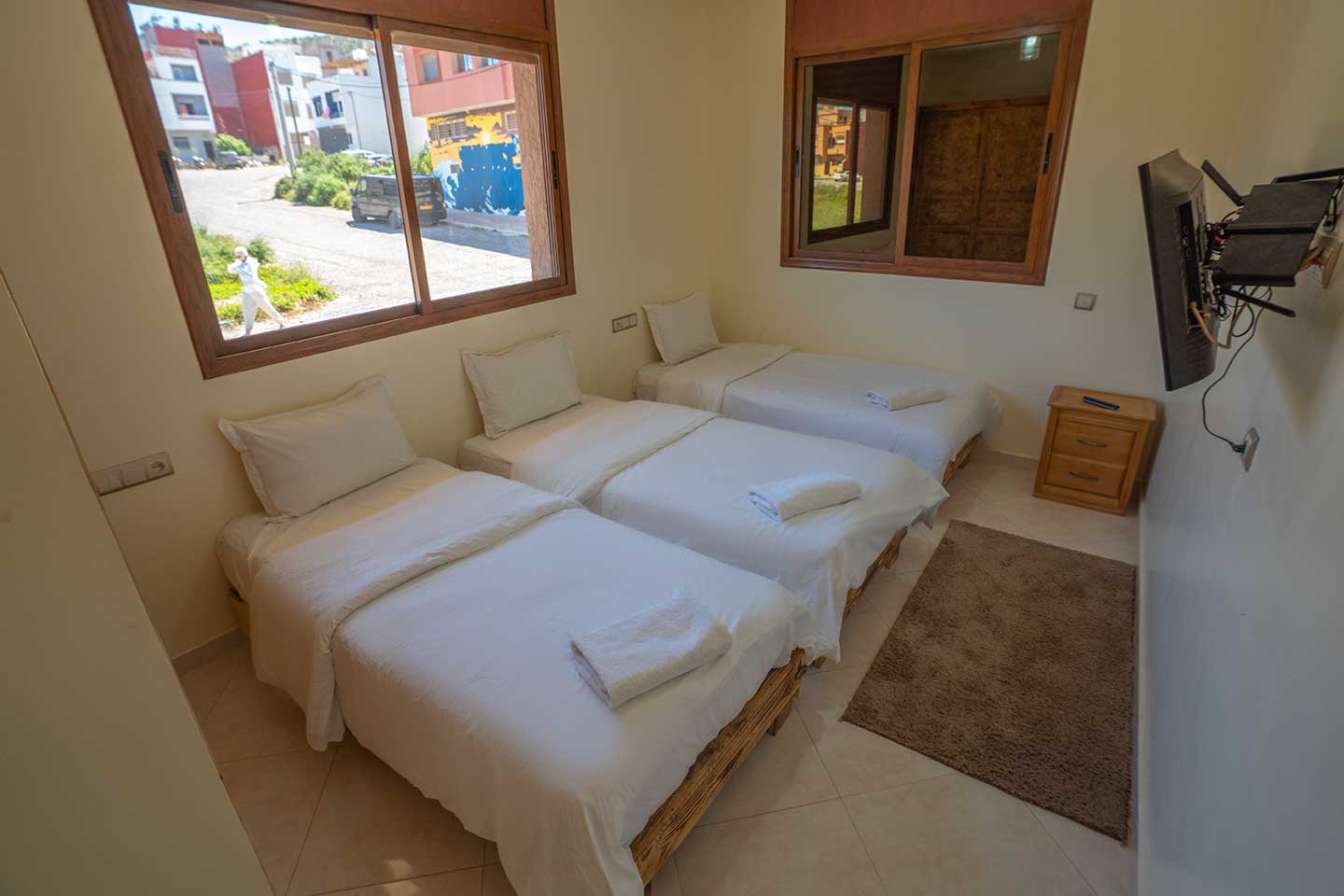 Triple bedroom with one double and one single bed at Golden Wave surf camp