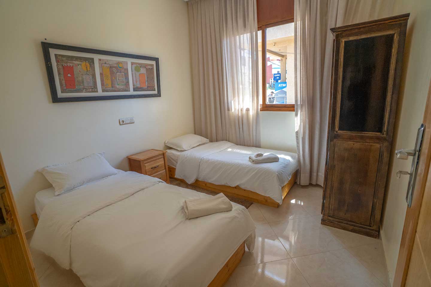 Twin bedroom with two single beds at Golden Wave surf camp
